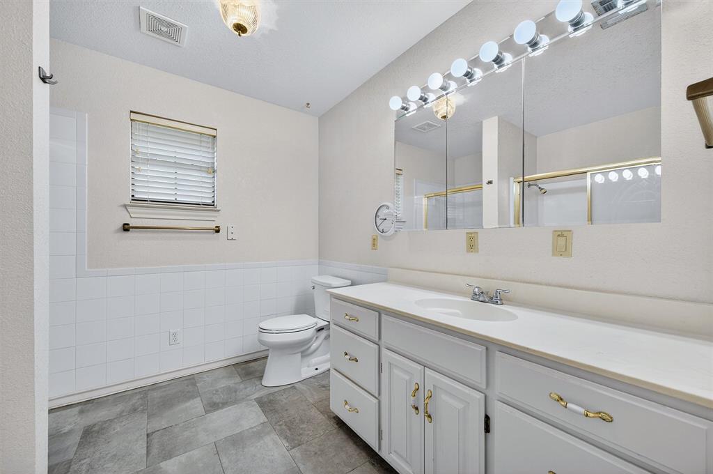 443 Lakewood Road Denison, TX 75020 - Photo 31 of 38 a bathroom with a double vanity sink mirror and toilet