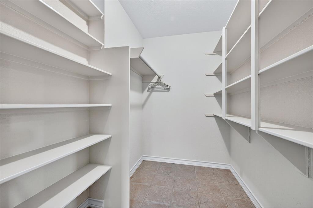 443 Lakewood Road Denison, TX 75020 - Photo 34 of 38 a view of walk in closet with empty racks