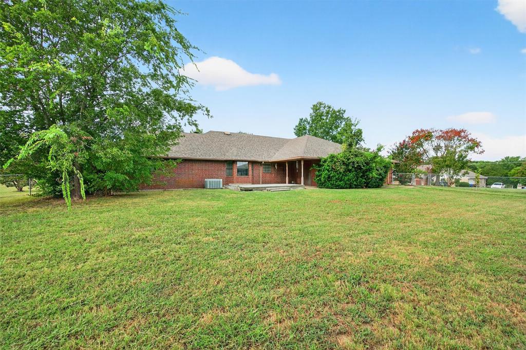 443 Lakewood Road Denison, TX 75020 - Photo 35 of 38 a front view of a house with garden
