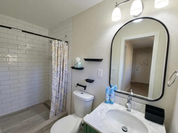 a bathroom with a sink toilet and shower