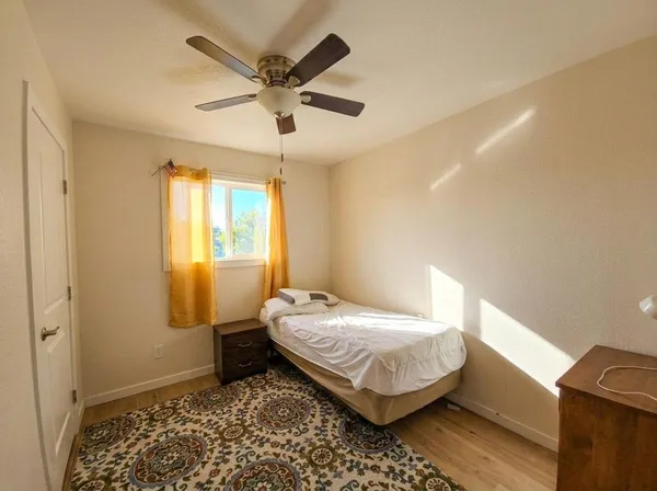 a bedroom with a bed and a window