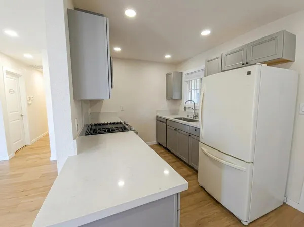 a white refrigerator freezer sitting inside of a kitchen