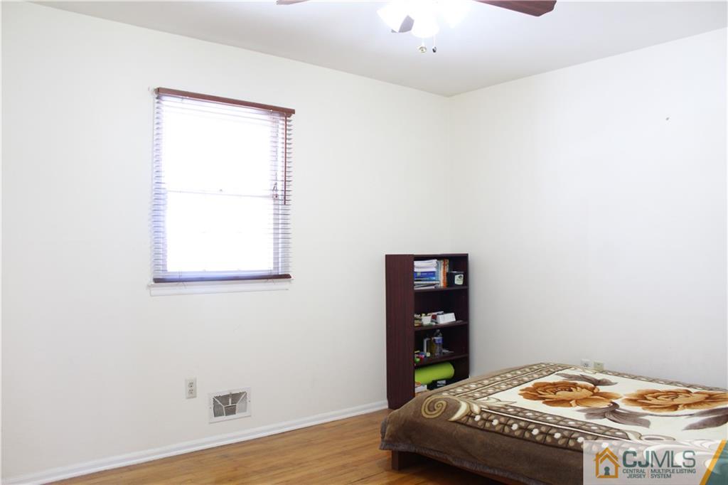 23 Hilltop Road Edison, NJ 08820 - Photo 11 of 17 a bedroom with a bed and a table