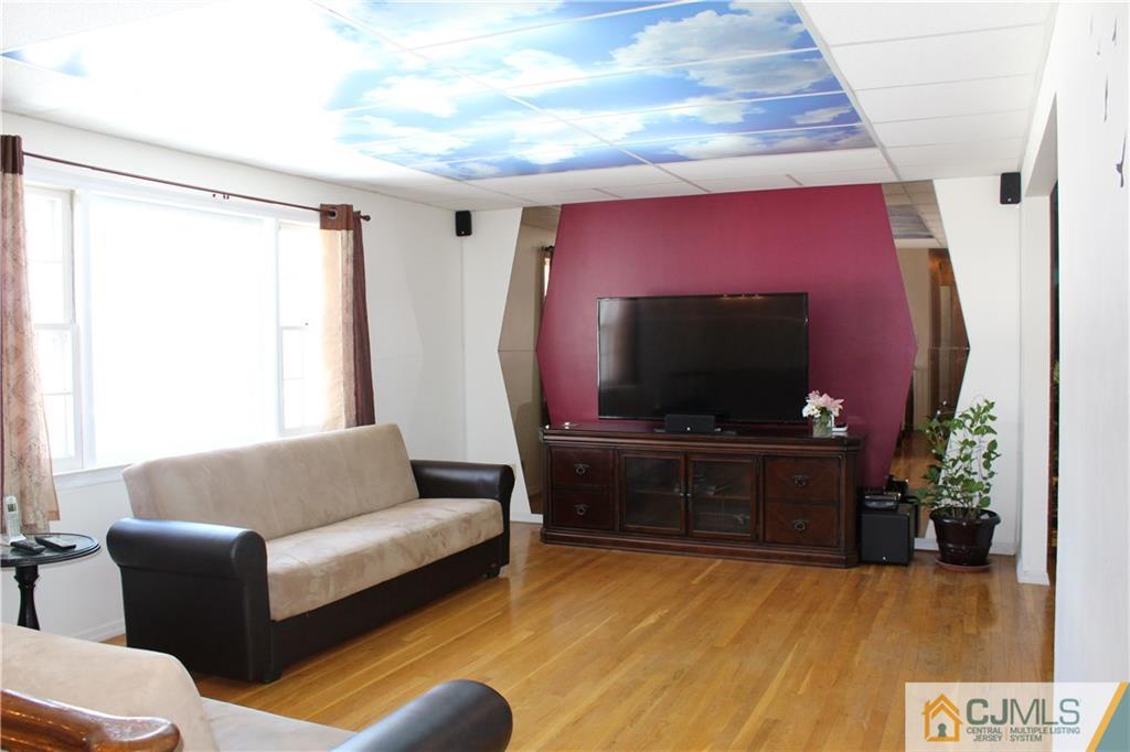 23 Hilltop Road Edison, NJ 08820 - Photo 3 of 17 a living room with furniture and a flat screen tv