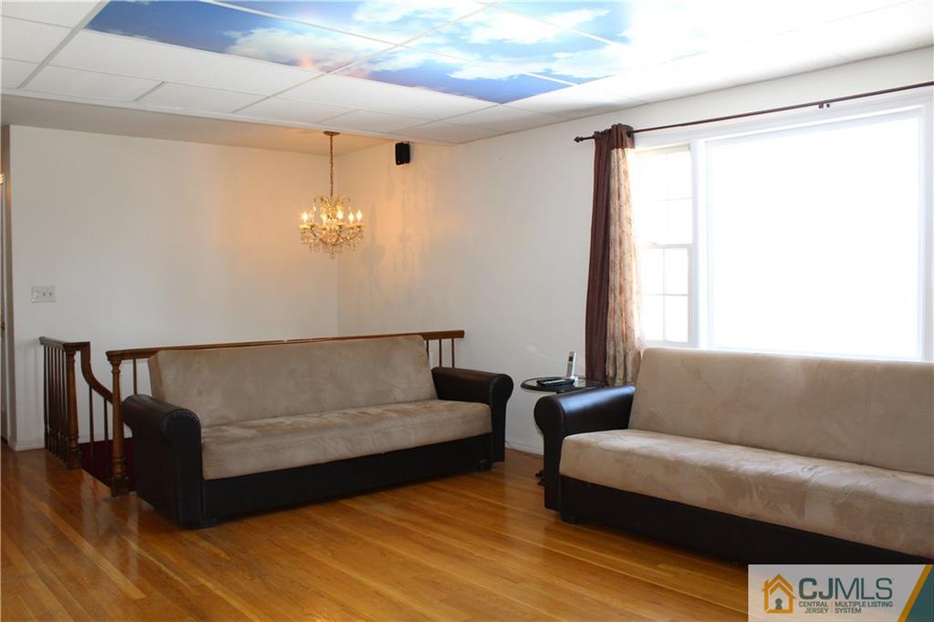 23 Hilltop Road Edison, NJ 08820 - Photo 4 of 17 a living room with furniture and a large window