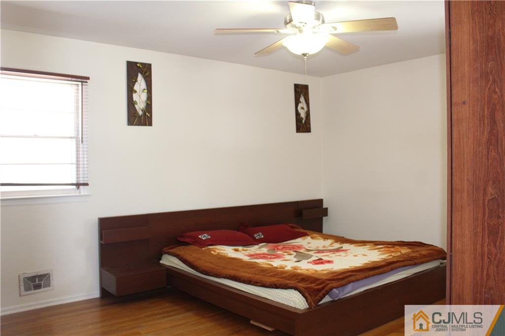 23 Hilltop Road Edison, NJ 08820 - Photo 8 of 17 a bed sitting in a bedroom next to a window