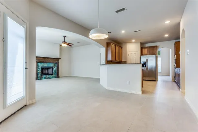 a view of a kitchen with a sink and a refrigerator