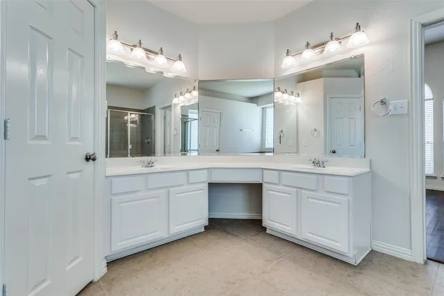 a bathroom with a double vanity sink and a mirror