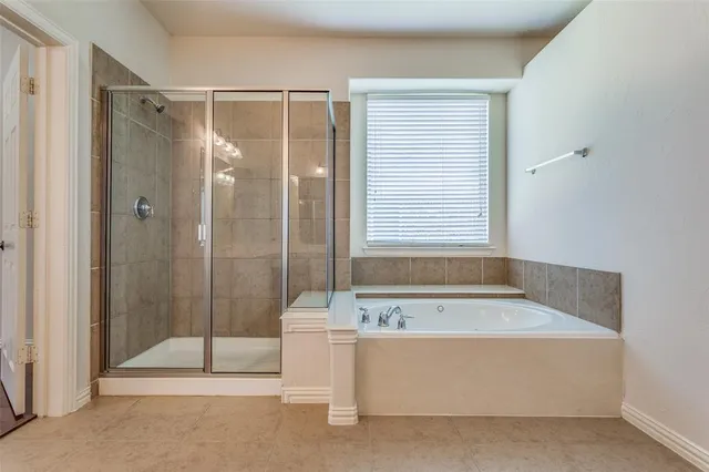 a bathroom with a bathtub and a shower