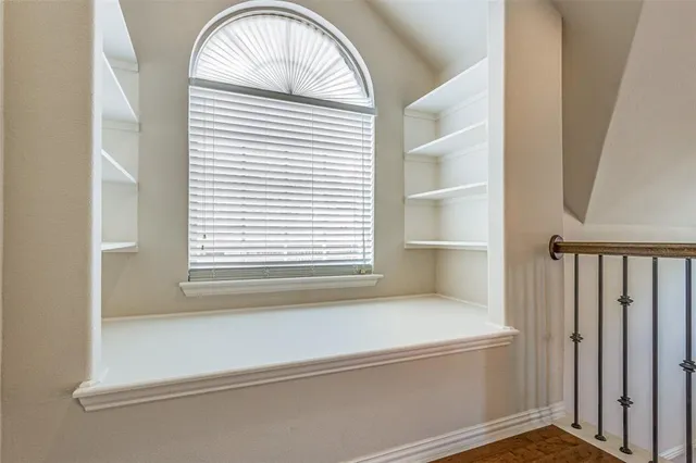a bathroom with a bathtub and a window