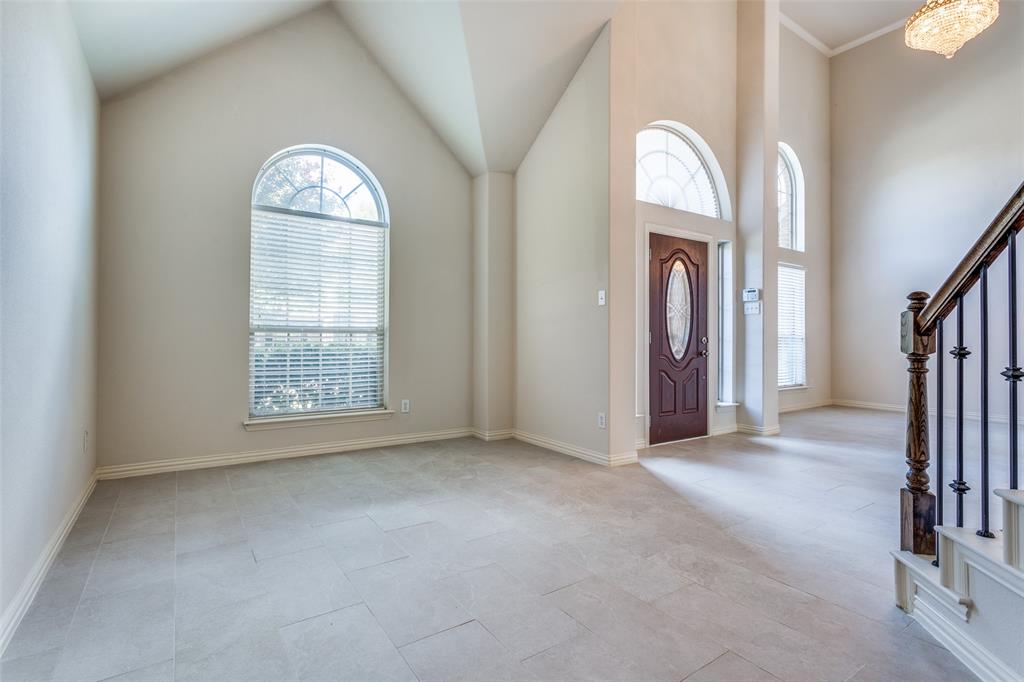 1104 Carson Drive Allen, TX 75002 - Photo 5 of 36 an empty room with a fireplace and windows
