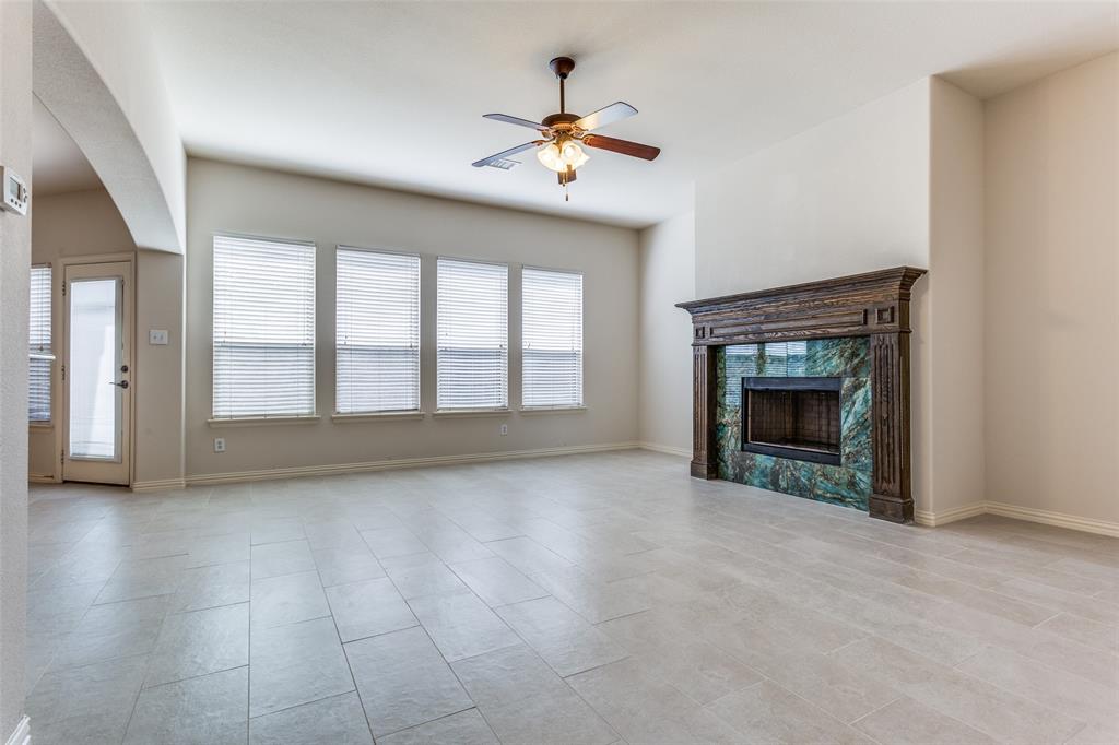 1104 Carson Drive Allen, TX 75002 - Photo 7 of 36 an empty room with chandelier fan and windows
