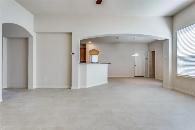 an empty room with a empty space and windows