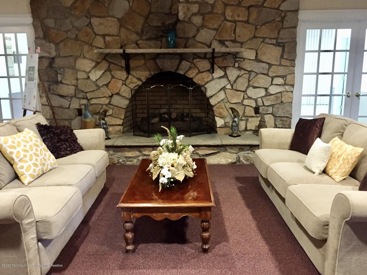 9 Phillips Road Brick, NJ 08724 - Photo 22 of 26 a living room with furniture and a fireplace