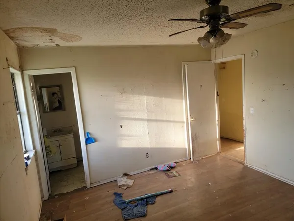 a view of a room with a hanging light and a window