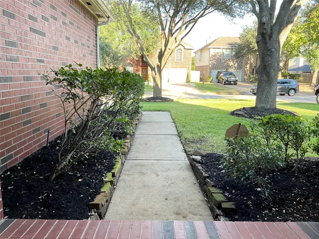 a yellow and red umbrella sitting in front of a house