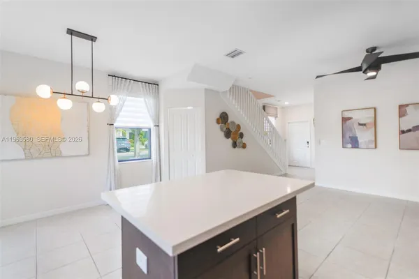 a kitchen with a table chairs and wooden floor