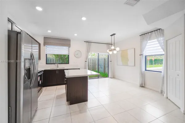 a kitchen with kitchen island a counter top space appliances and a counter top space