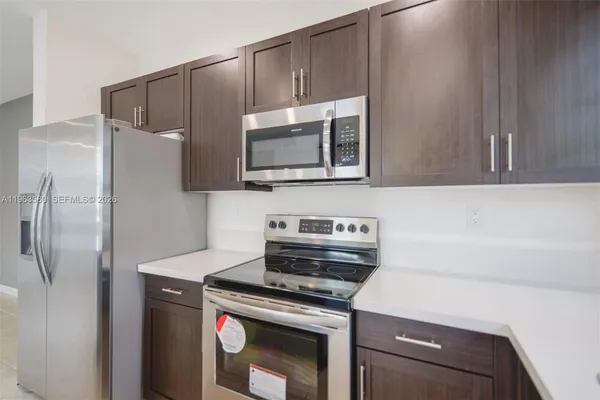 a kitchen with a stove and a microwave