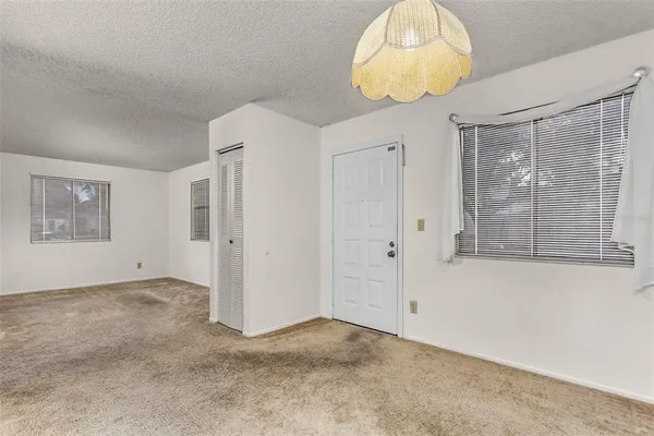 en empty room with window and wooden floor
