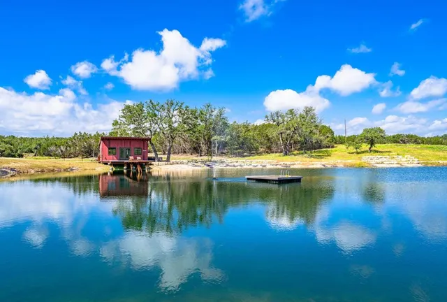 a view of residential houses with outdoor space and lake view