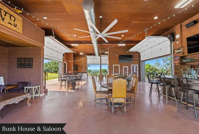 a view of a patio with table and chairs and wooden floor