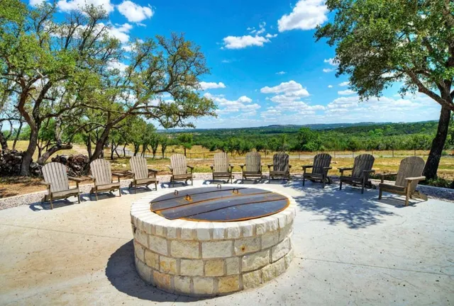 a backyard of a house with barbeque oven table and chairs