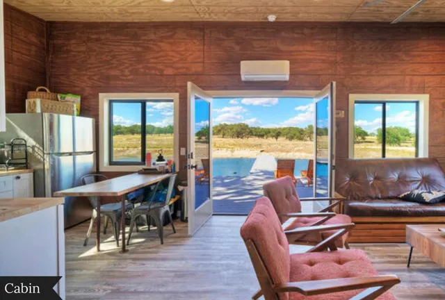 a view of a house with backyard and a tree