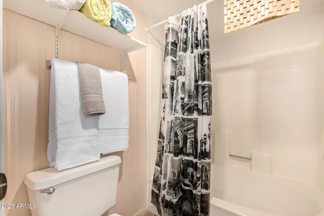 a bathroom with a toilet and shower