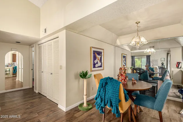 a view of a dining room with furniture and chandelier