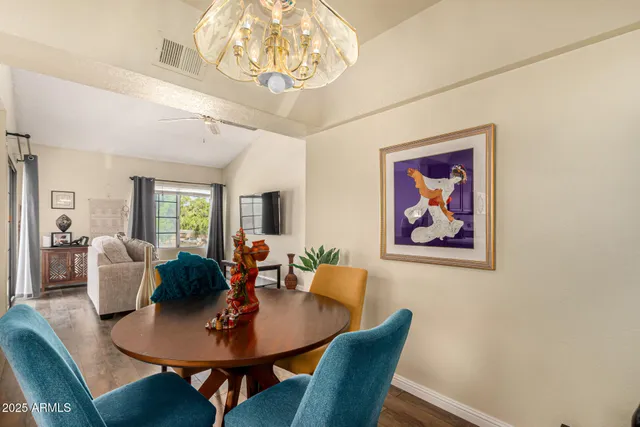 a view of a dining room with furniture wooden floor and chandelier