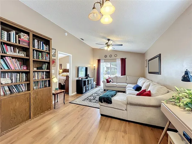 a living room with furniture and a book shelf