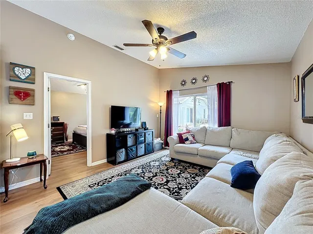 a living room with furniture a window and a flat screen tv