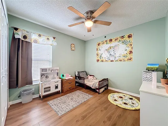a bedroom with furniture and a large window