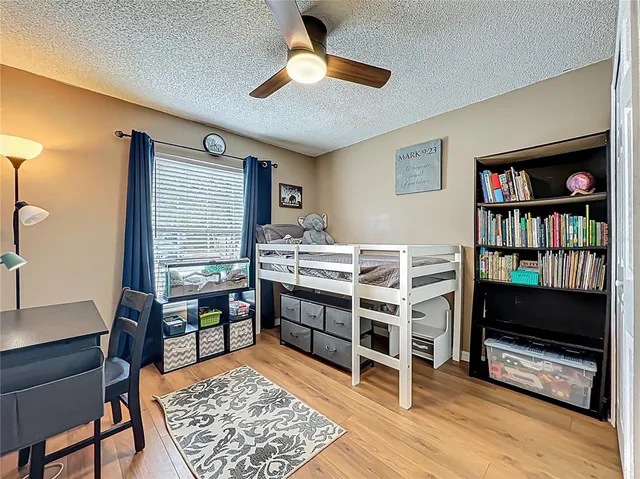 a bedroom with furniture and a book shelf