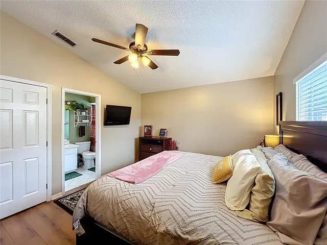 a bedroom with a bed and a flat screen tv