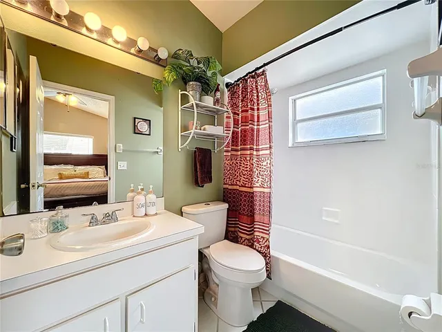 a bathroom with a sink a toilet a mirror a vanity and shower