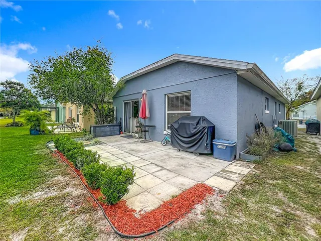 a backyard of a house with yard and outdoor seating