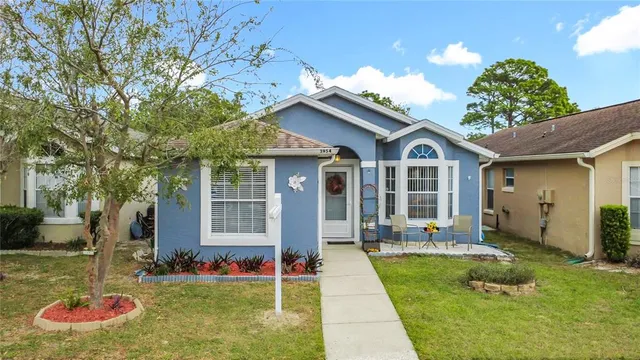 a front view of a house with a yard table and chairs