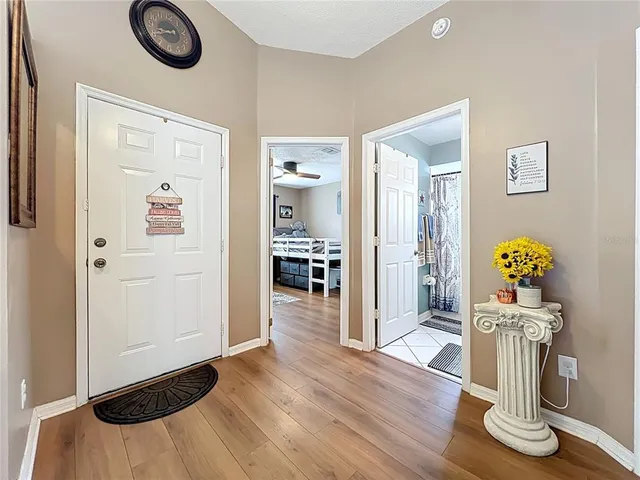 a view of empty room with wooden floor