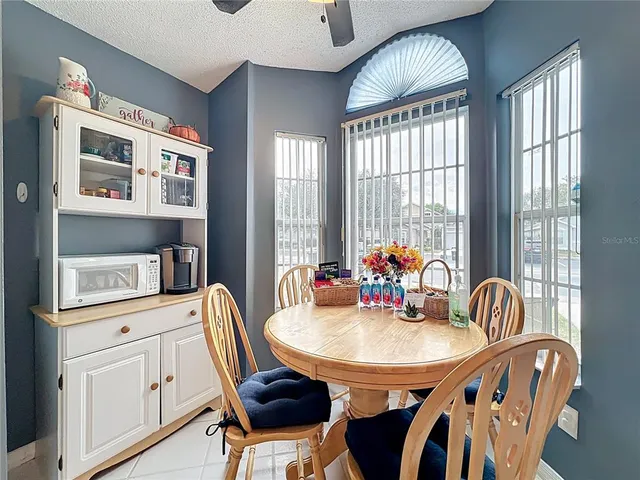 a dining room with furniture a chandelier and window