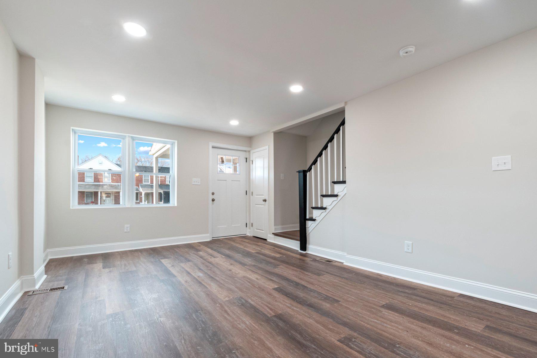 7324 Kirtley Road Baltimore, MD 21224 - Photo 5 of 27 a view of an empty room with wooden floor and a window