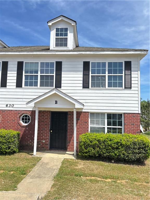 630 Mill Stone Bluff, Unit B Monroe, GA 30655 - Photo 1 of 14 a front view of a house with a yard