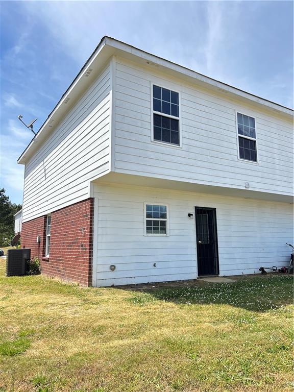 630 Mill Stone Bluff, Unit B Monroe, GA 30655 - Photo 2 of 14 a front view of a house with a yard