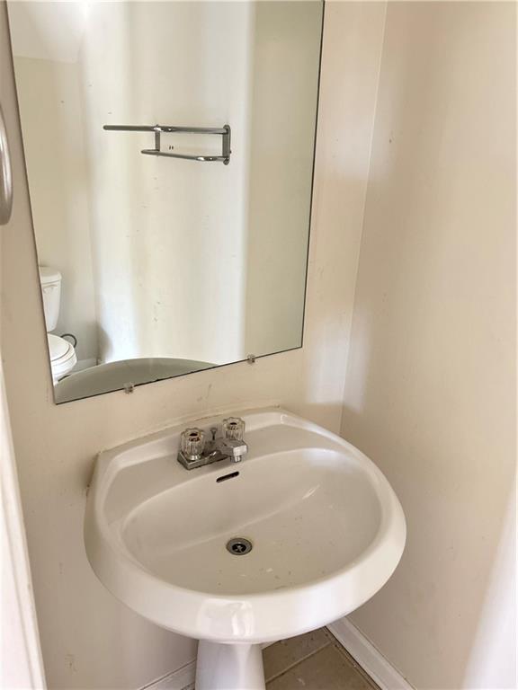 630 Mill Stone Bluff, Unit B Monroe, GA 30655 - Photo 6 of 14 a bathroom with a sink and a mirror