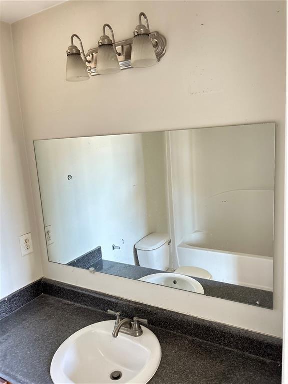 630 Mill Stone Bluff, Unit B Monroe, GA 30655 - Photo 8 of 14 a bathroom with a sink and a mirror