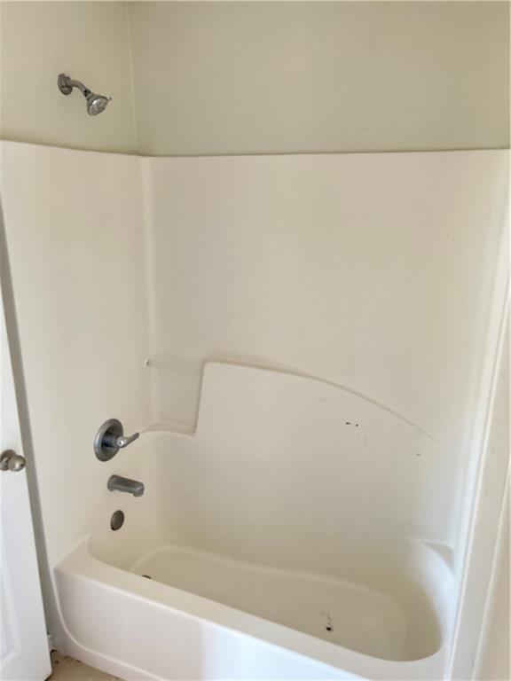 630 Mill Stone Bluff, Unit B Monroe, GA 30655 - Photo 9 of 14 a bathroom with a bathtub