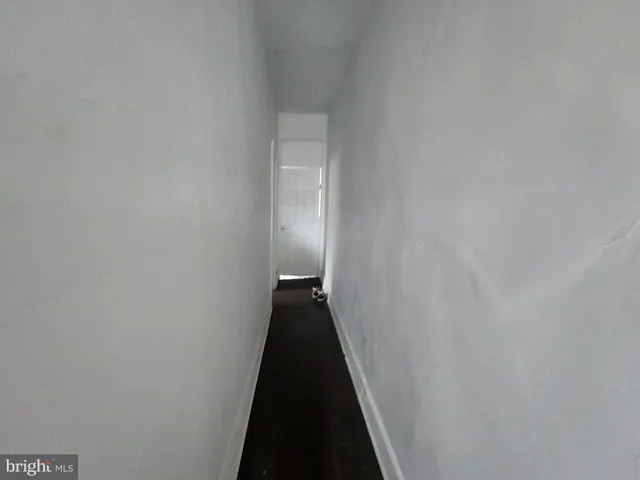 a view of a hallway with stairs