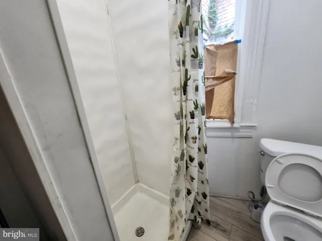 a bathroom with a toilet and a shower