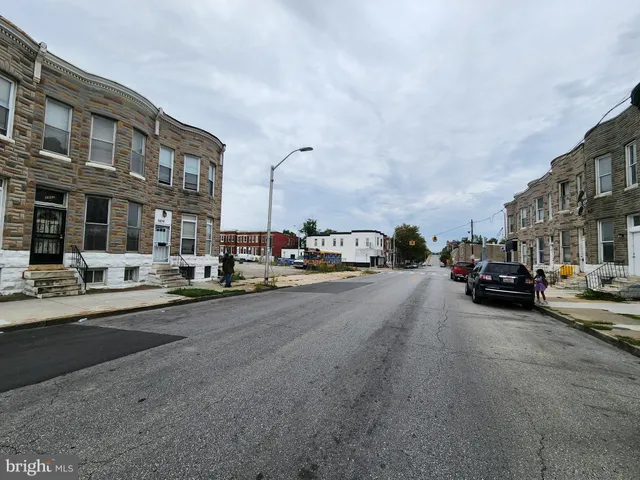 a couple of cars parked in front of a building